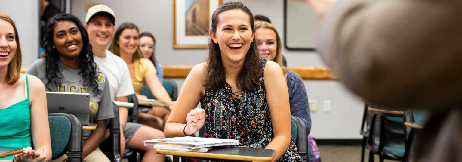 Students smiling sitting in a classroom